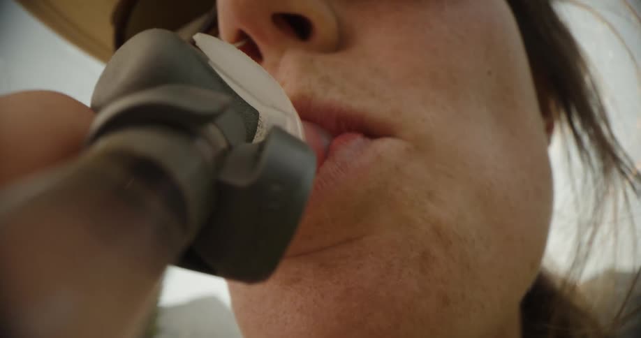 A woman sips from a straw