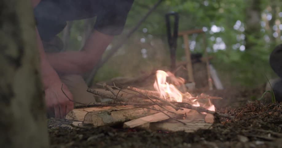A man starts a campfire