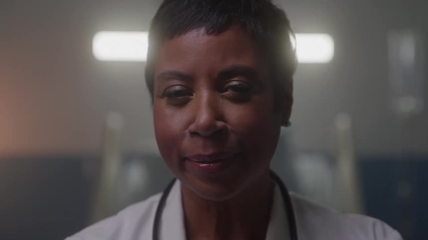 Close up portrait of a young black female doctor in a room