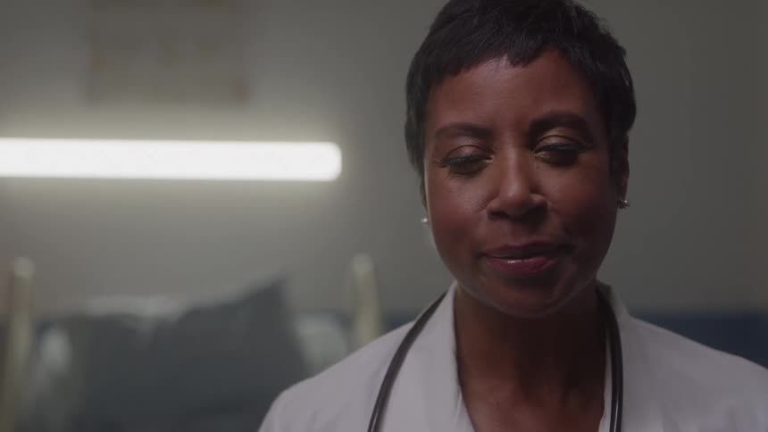 The doctor is smiling and blinking