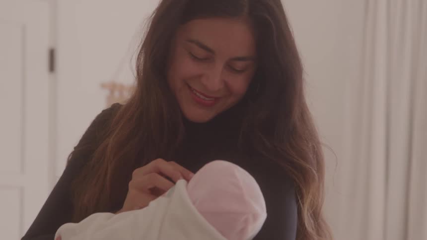 Loving gaze of a mother holding her baby in her arms