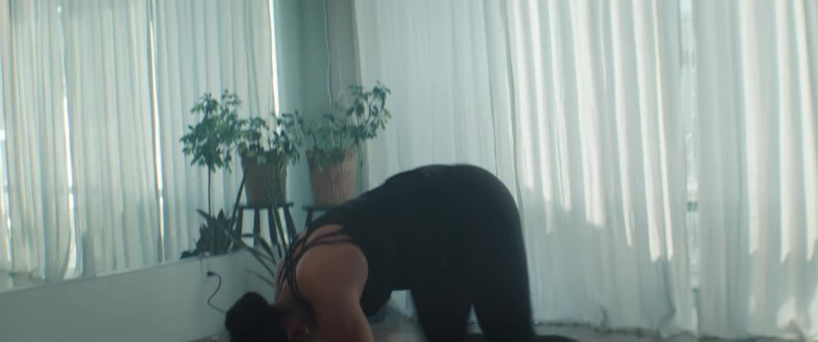 The woman is twisting and kicking as she dances