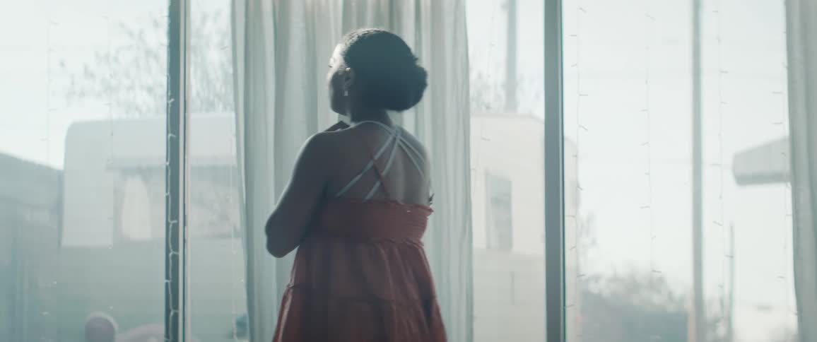 The woman spins multiple times and sways her arms while dancing