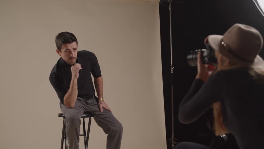 The model is posing for a photographer
