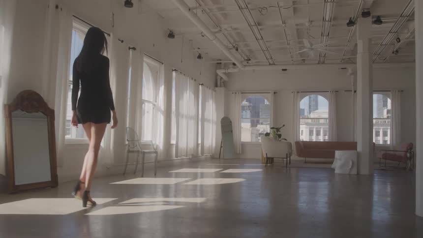 A woman walks in a large room