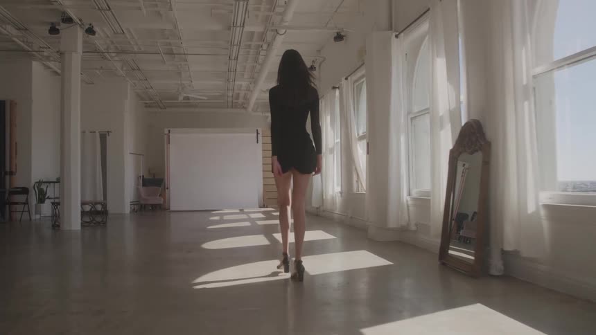 Woman walks gracefully through a spacious welllit studio
