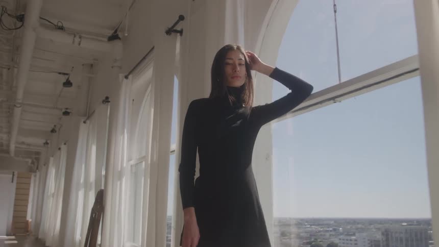 The model poses by the window
