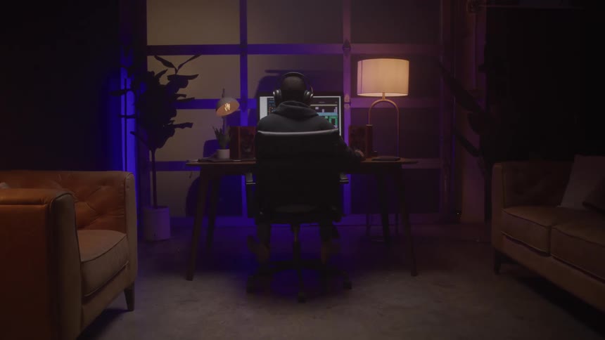 A man sits at his computer