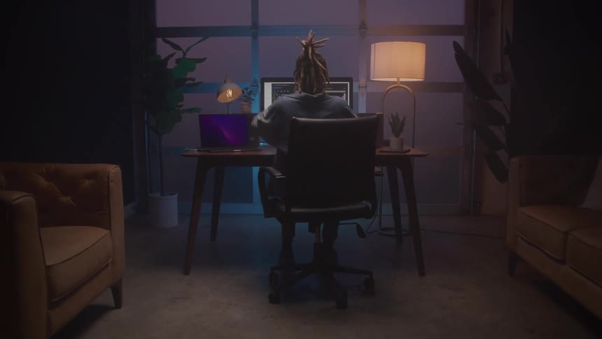 A man sits at his computer