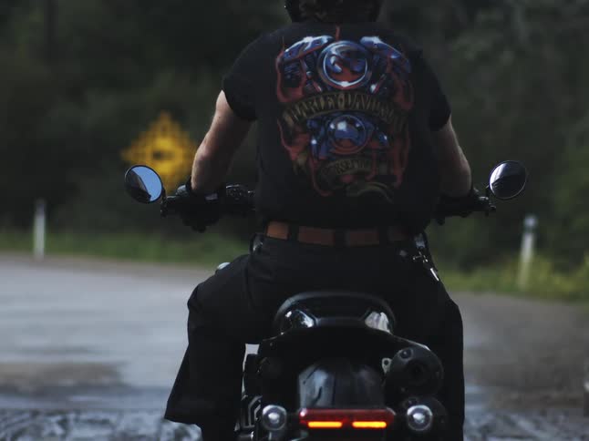 Motorcyclist wears black harleydavidson tshirt while riding
