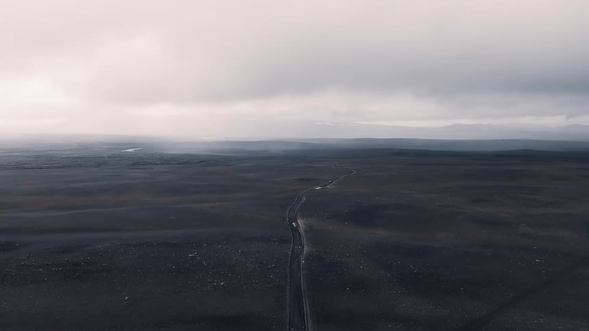 The barren landscape has a trail running through it