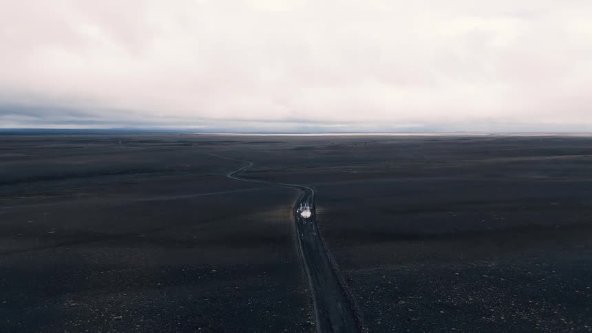 A busy countryside highway with cars passing by at sunset