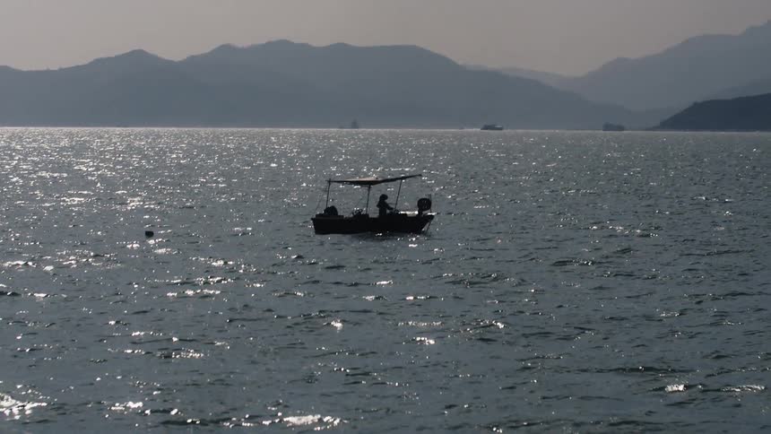 A person sailing a small boat at sea during daytime