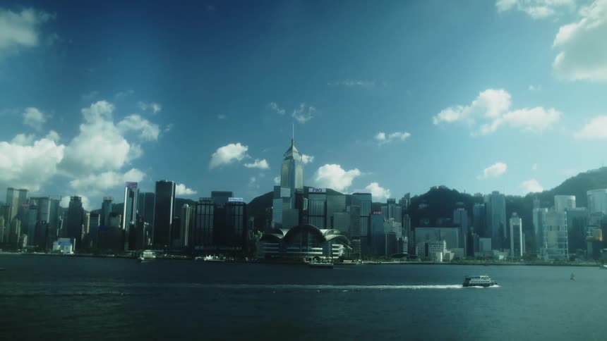 A modern city skyline with tall skyscrapers viewed across the water