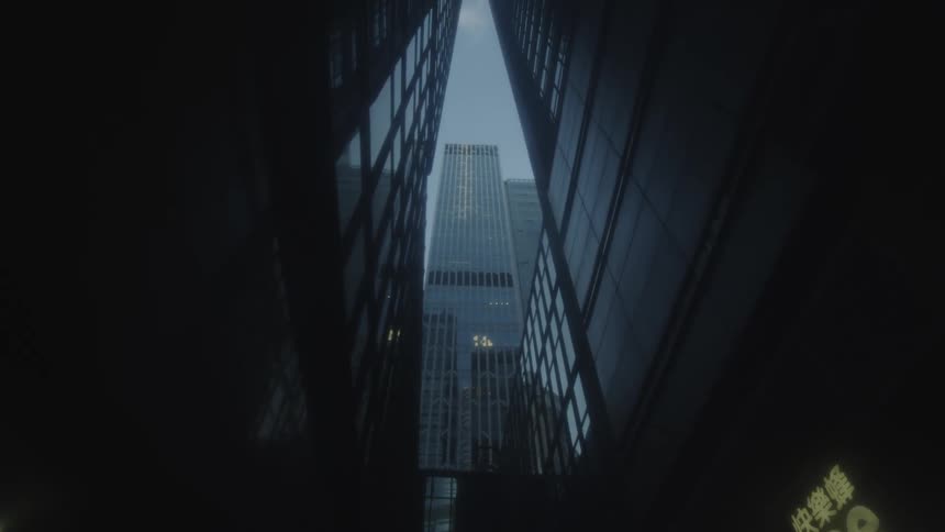 Static lowangle view looking upward between two parallel structures framing a taller centrally positioned skyscraper against a strip of sky with a lit sign partially visible at the bottom right