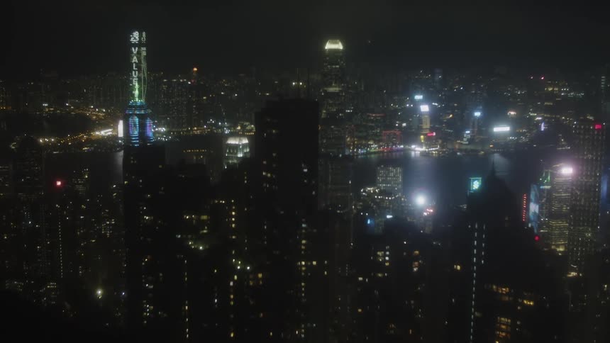 City skyline with skyscrapers reflecting across the harbor at night