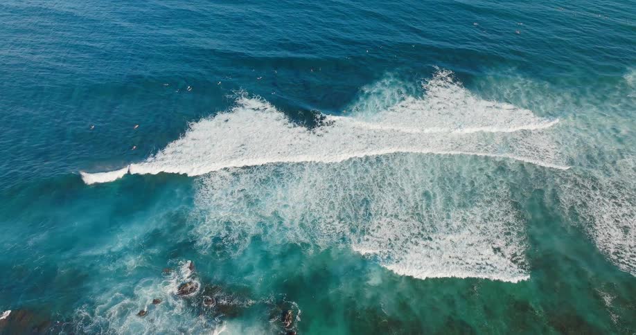 The small waves crash on the shore