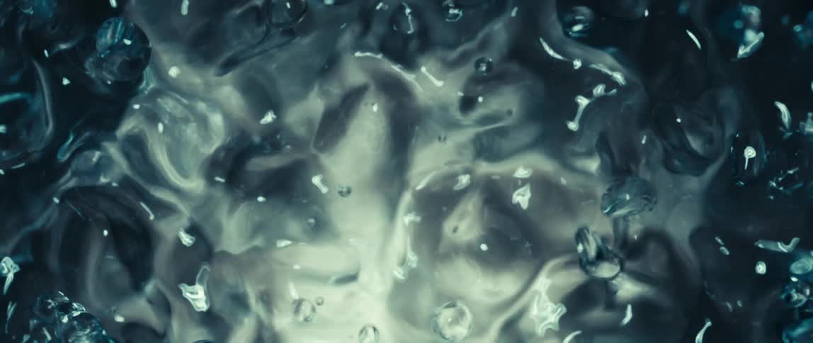 Water bubbles form in motion under soft light