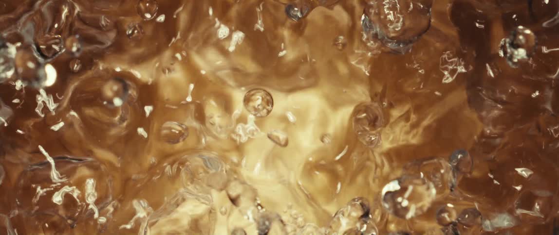 The water boils and drops fly up from the pool