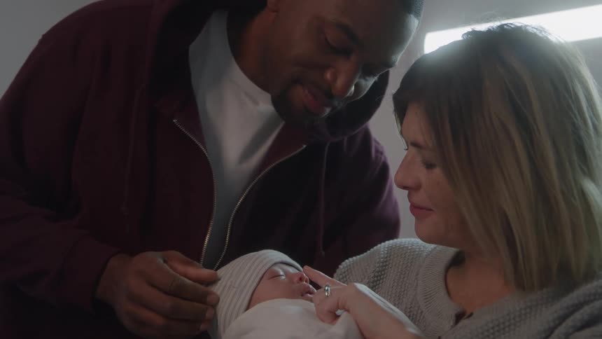 Parents are admiring their newborn