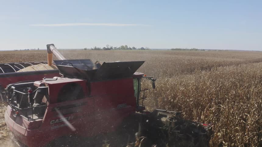 The tractor is harvesting the landscape of crops