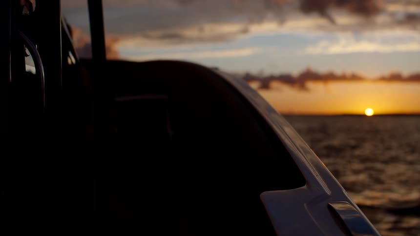 On a boat at sunset
