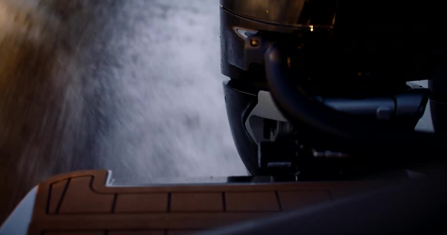 Stream of water being released from the back of a moving boat
