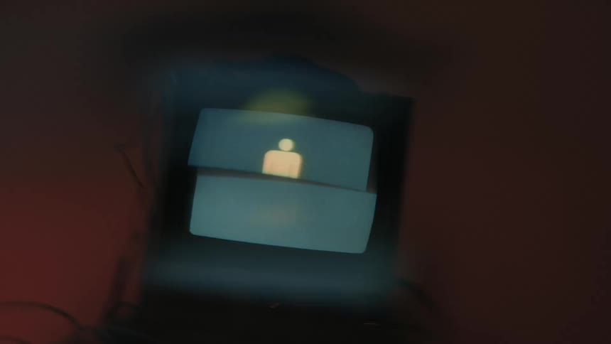 Small computer screen displays a series of white symbols on a blue background