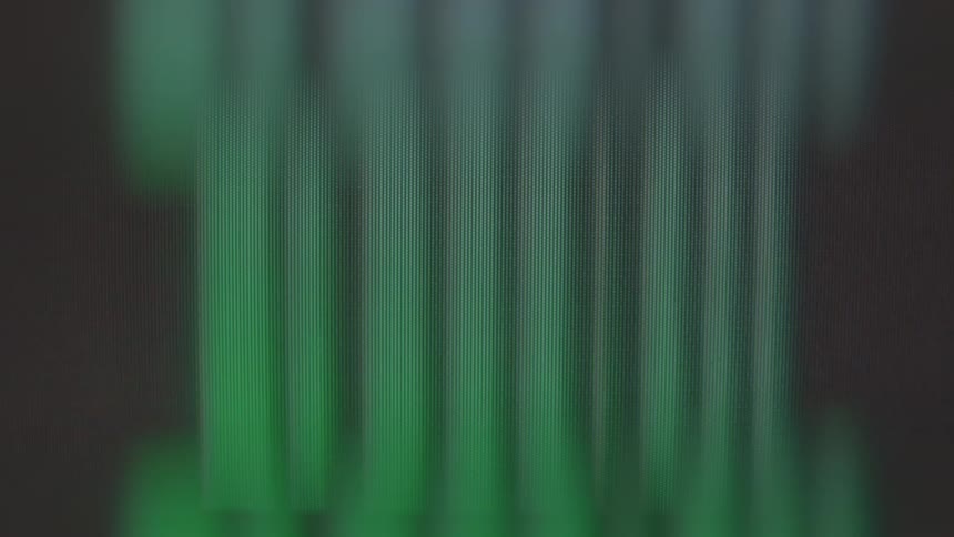 Closeup of a screen displaying green signals against a black background