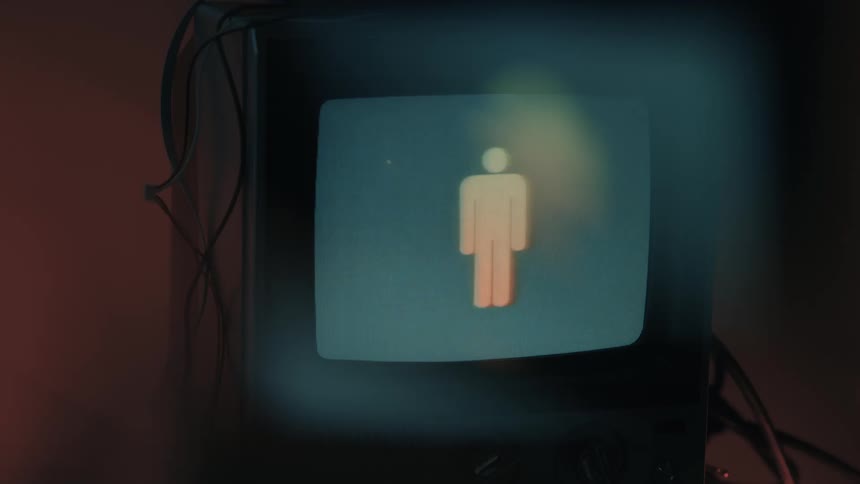 Closeup of old tv showing flickering icons on screen