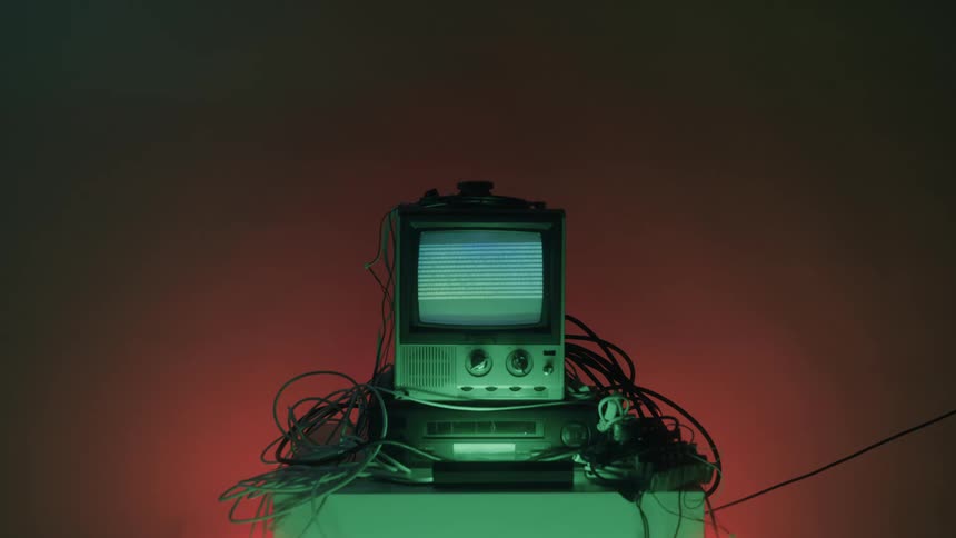 A connected electronic display device on a table showing binary digits on its screen