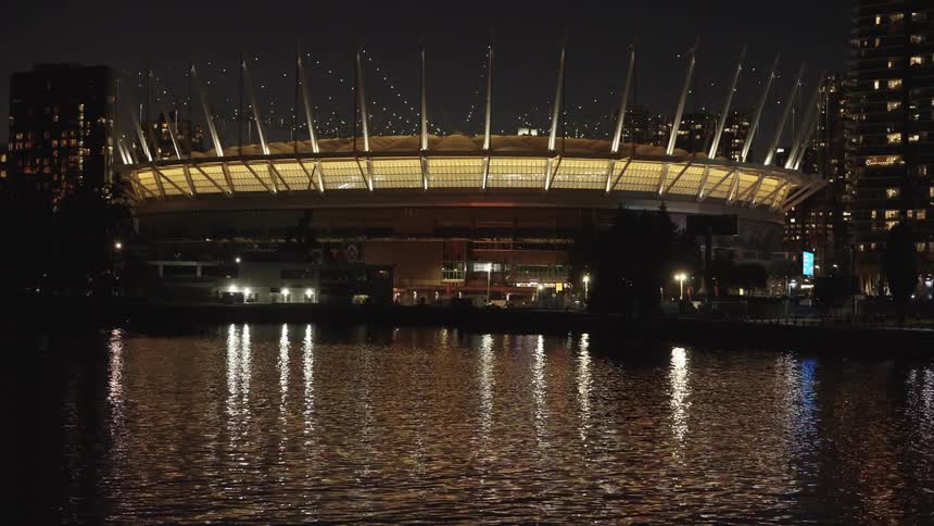 The stadium lights up the water in the city
