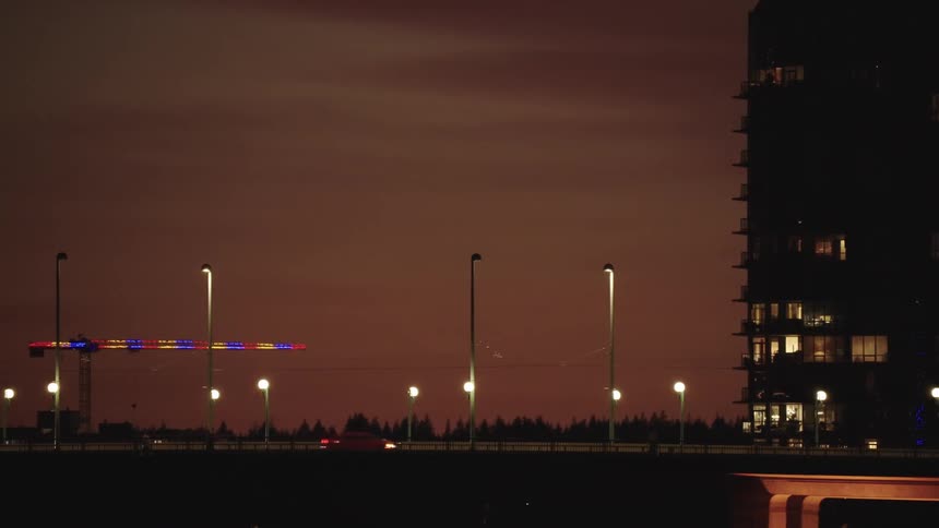 The traffic travels over the bridge in the city