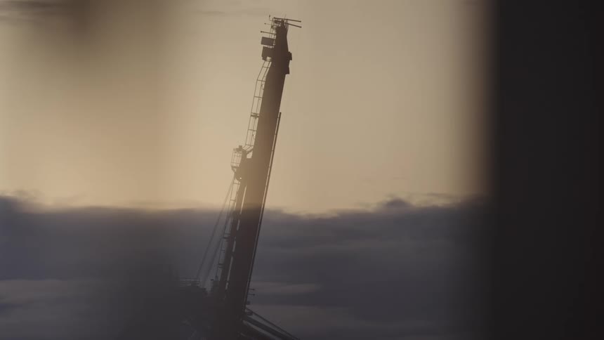 Loading structure stands on the waterfront on a cloudy evening