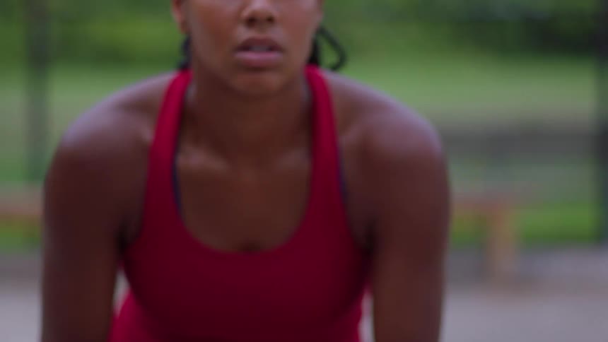Woman wearing red sportswear during outdoor physical activity