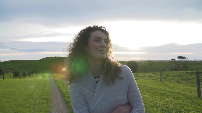 Smiling woman walks down path