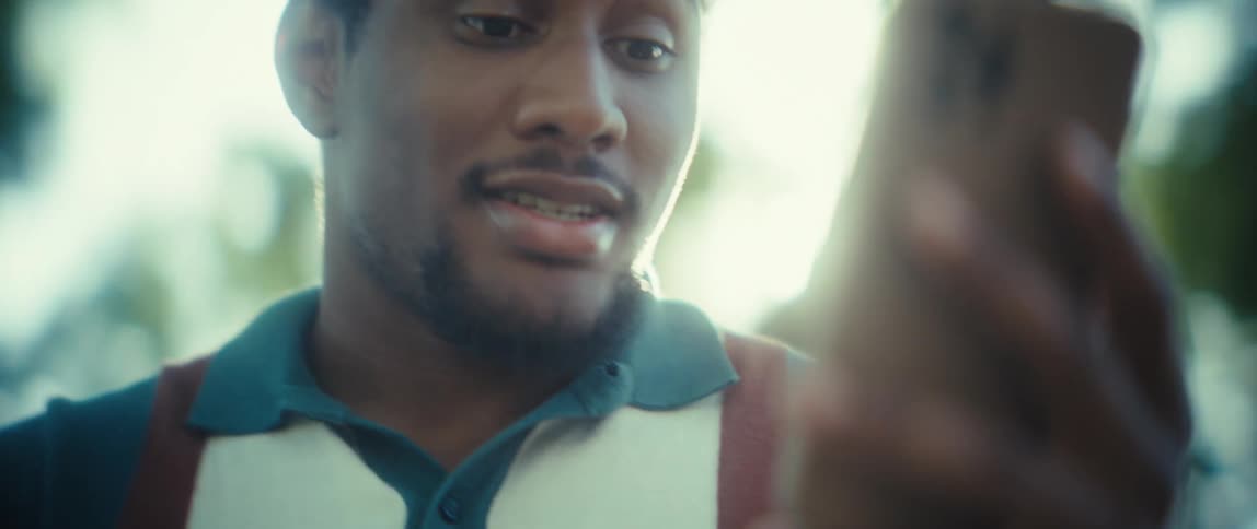 The man gets happy while looking at his phone