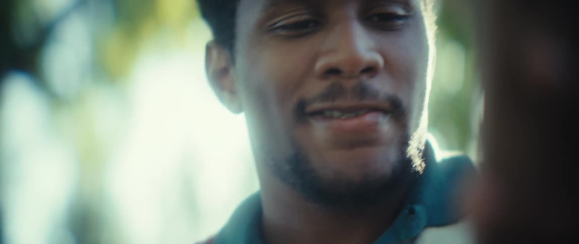 Man looking at his phone with a calm expression