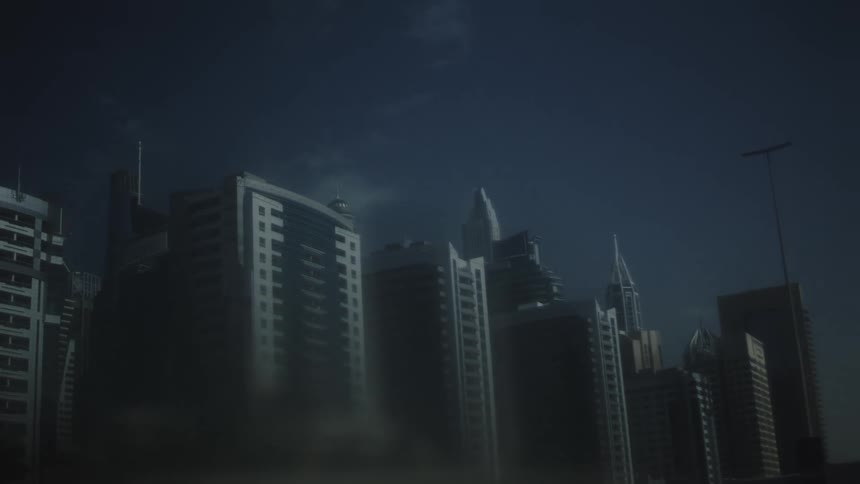A nighttime cityscape filled with numerous highrise buildings and towering skyscrapers