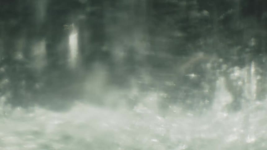 Heavy rain falling and splashing on the surface