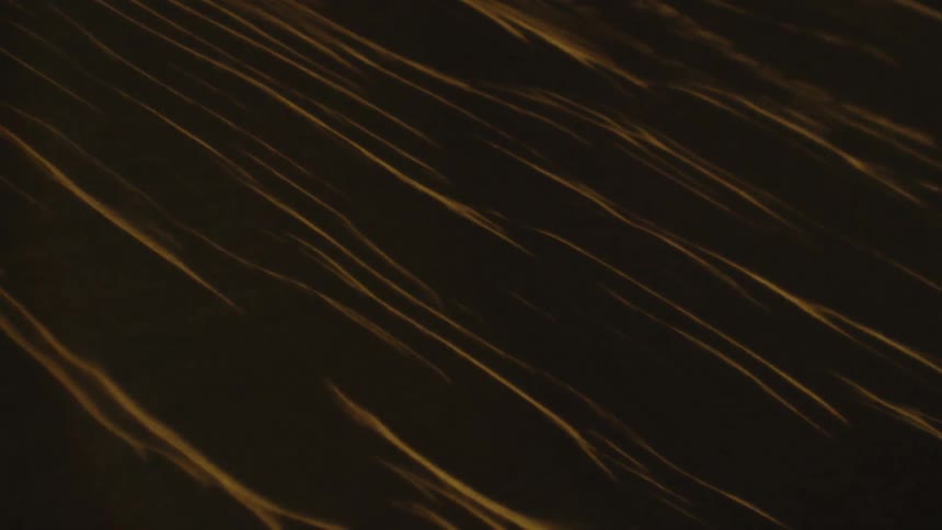 Bright light illuminates a dark desert slope