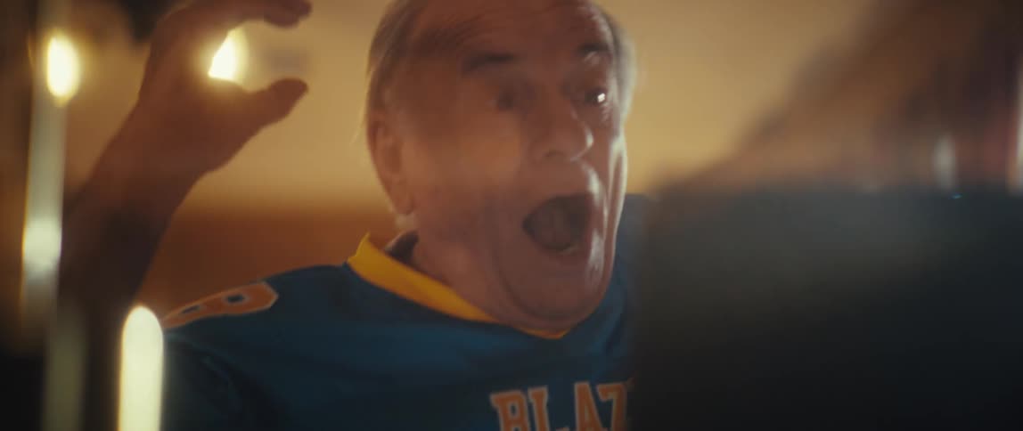 Elderly man with happy and vibrant expression watching on a tablet