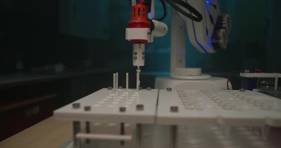 A robotic arm moves components back and forth in the workshop