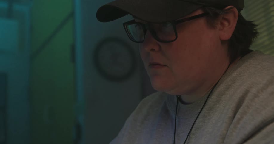 Close up of a young man working while sitting in a room