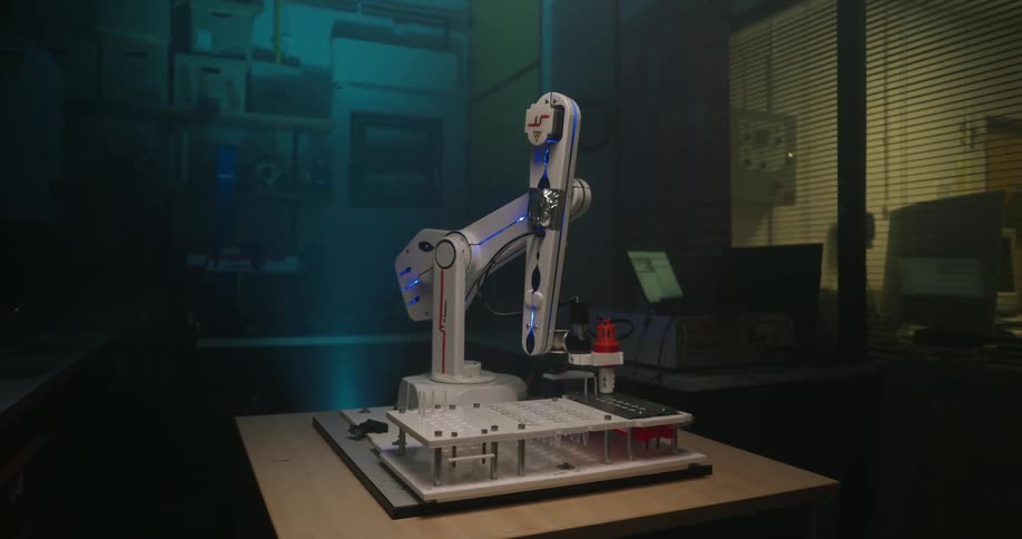 The robotic arm is inserting a needle into vials