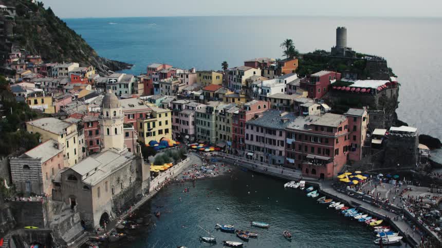 Coastal village with colorful houses and a small harbor surrounded by boats