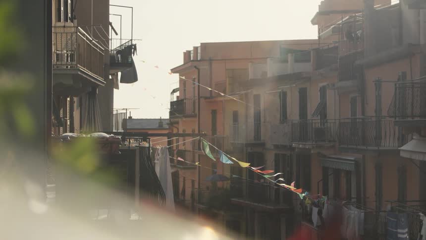 Clothes hangs from the apartment balconies