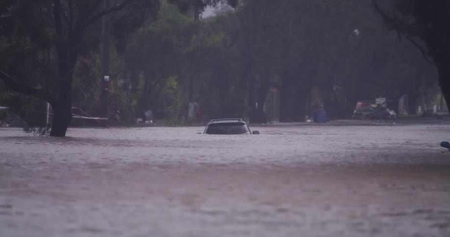 Car submerged in water in a flooded urban area during a storm outdoors at day time
