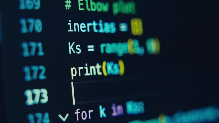 Close up of a computer screen displaying a coding interface in use
