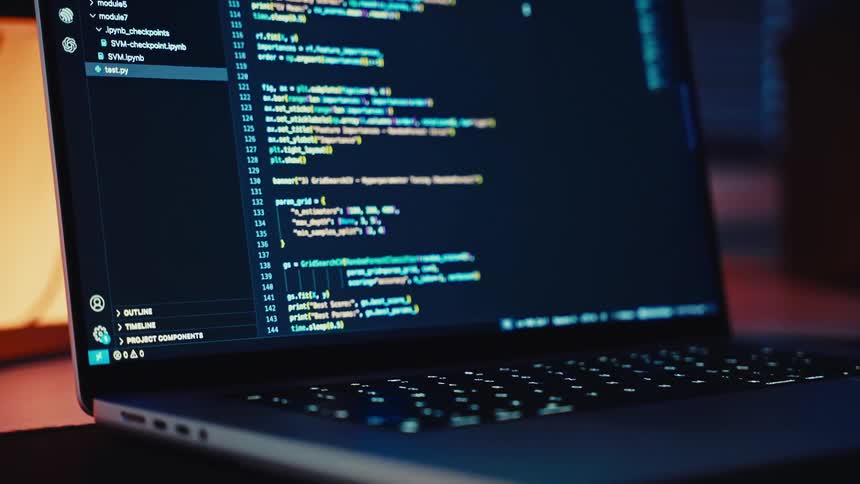 A highangle closeup shot of a laptop screen displays lines of python code with bright syntax highlighting against a dark background the code appears to be focused on machine learning algorithms with visible functions like randomforestclassifier
